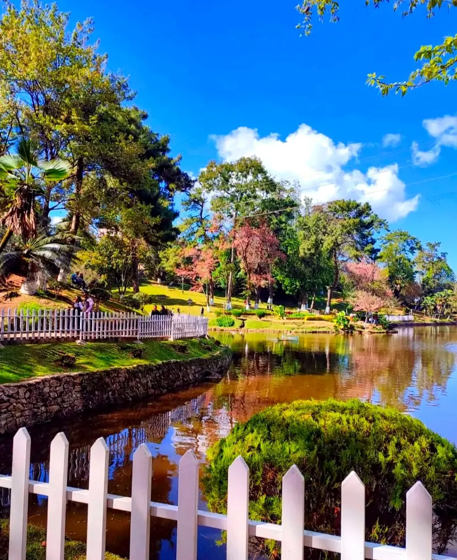 The white picket fence and still water of Ward's Lake, Shillong