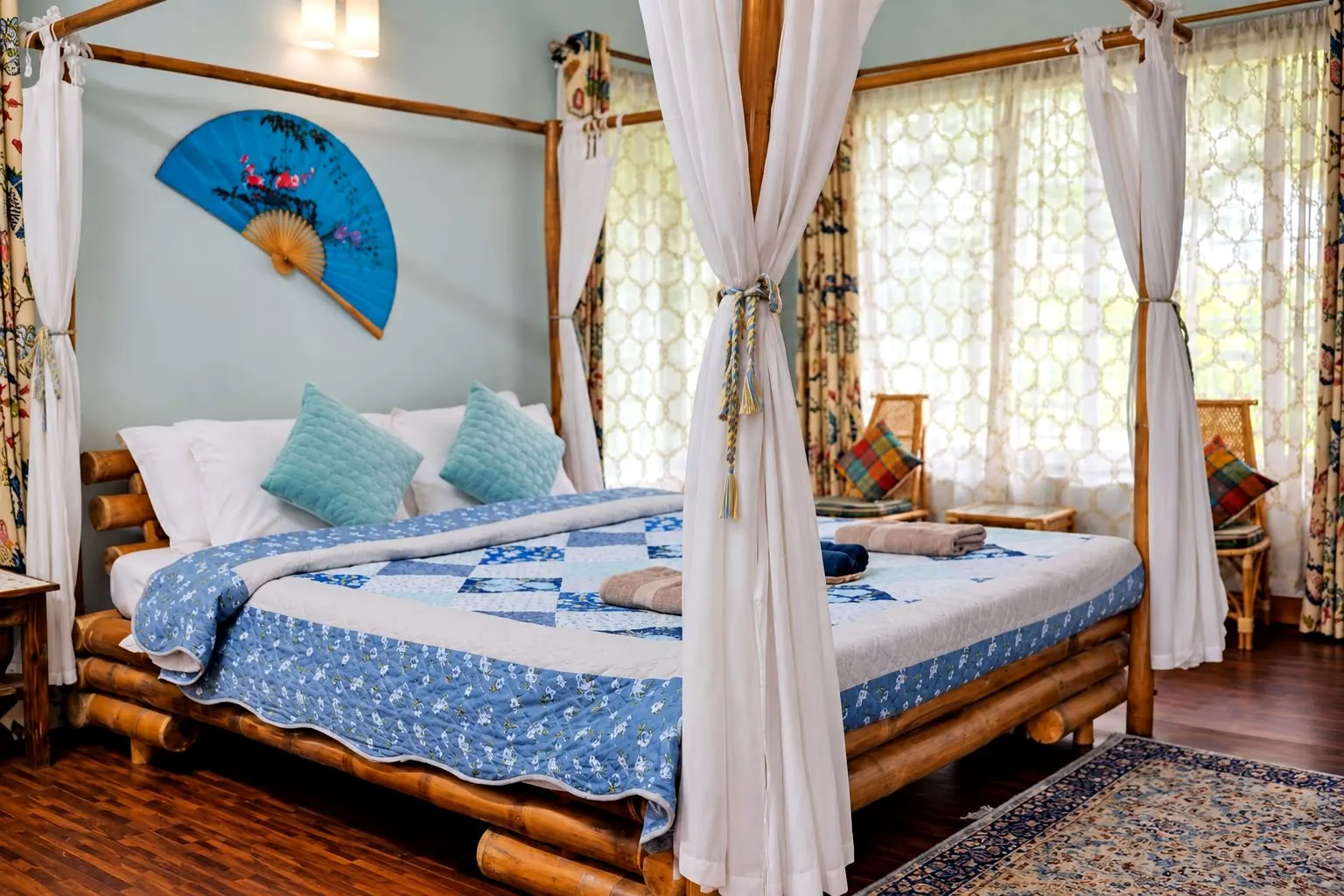 Bamboo room with a four-poster bamboo bed, sheer white canopy curtains and duck-egg blue walls