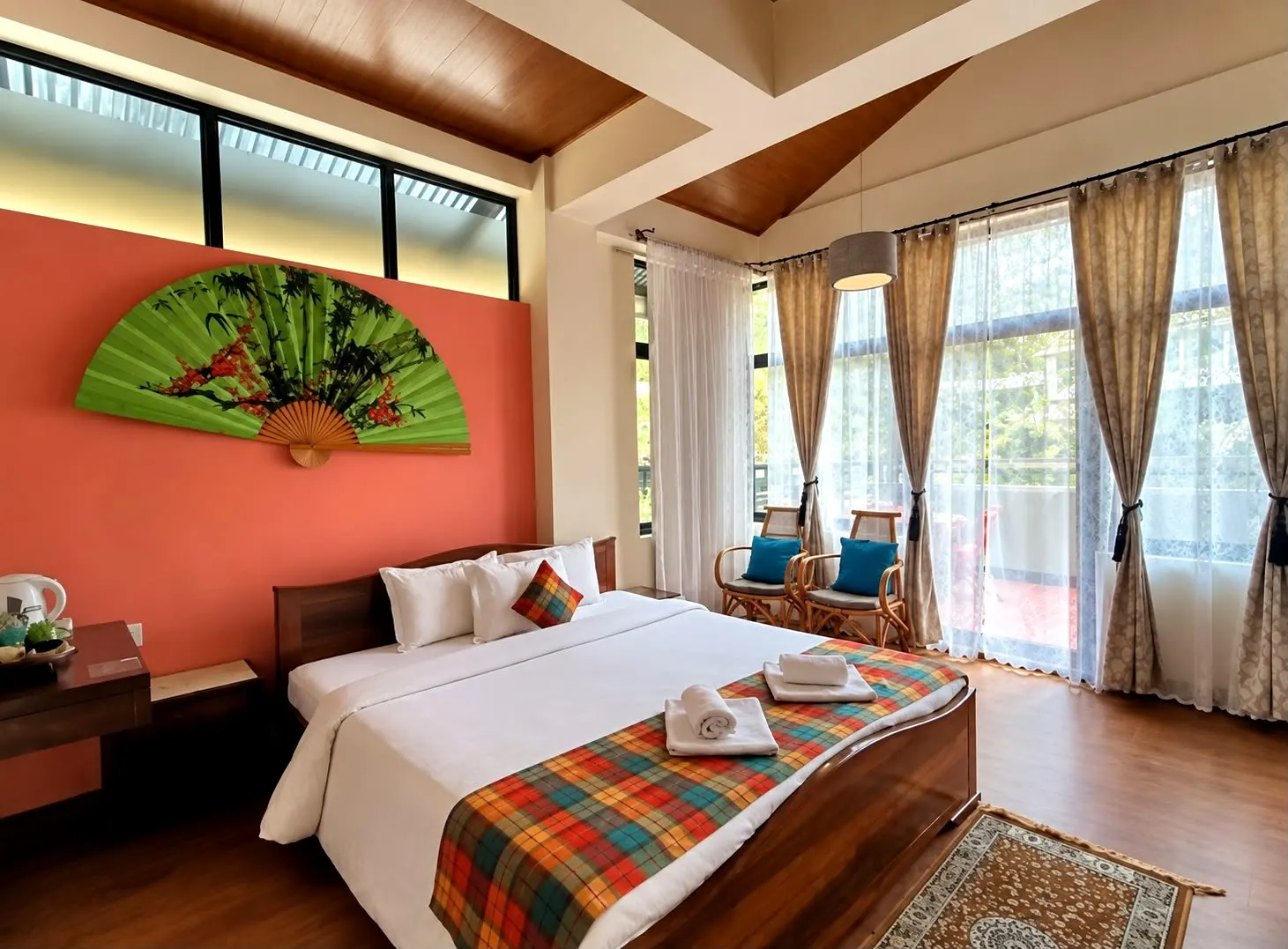 Pine room seen toward the balcony, with rattan chairs and teal cushions catching the morning light